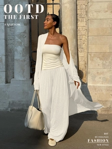 Detail of white waffle knit texture on 3-piece cardigan and wide-leg trousers set