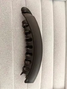 Macro detail of large matte black banana hair clip with curved multi-tooth comb structure