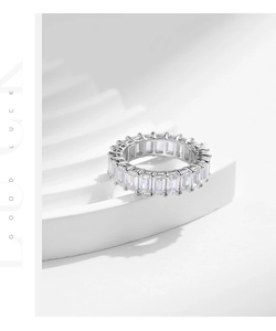 Macro detail of S925 silver eternity ring with square cubic zirconia on white steps