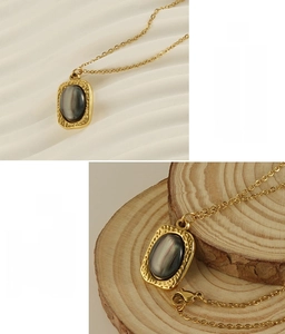 Detail of square gold pendant necklace with tiger eye stone inlay on varied backgrounds