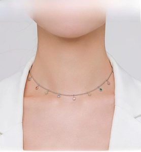 Detail of S925 sterling silver necklace with colorful gemstones worn on the neck