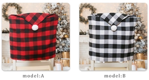 Detail of red and black buffalo plaid Christmas chair covers with white pom pom accents
