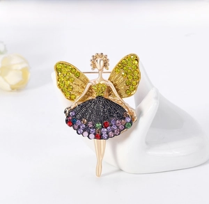 Detailed close-up of colorful rhinestone fairy brooch on a ceramic hand model