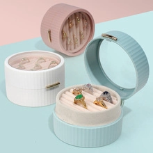 Detailed view of colorful strawberry velvet ring boxes in pink, white and blue