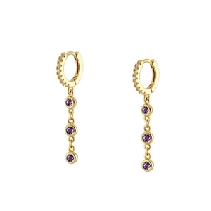 Detail of gold chain earrings with purple zircon stones and sparkling white accents