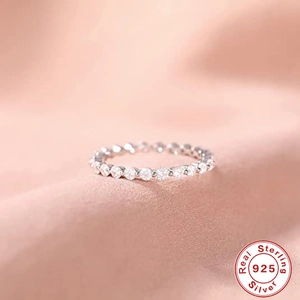 Macro shot of 925 sterling silver eternity band with sparkling round cut crystals