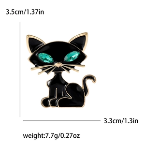 Cat brooch with black enamel, green gemstone eyes, and gold trim dimensions shown