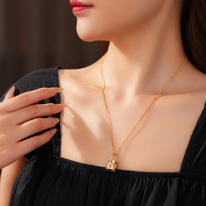 Close-up of gold flower basket pendant necklace with colorful enamel floral details