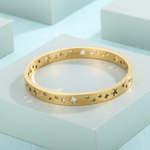Detailed view of hollow star patterns on an 18K gold-plated stainless steel bangle
