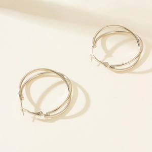 Detail view of silver double-layered round hoop earrings with minimalist metal finish