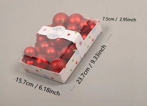 Detail view of red Christmas ornaments set in window box showing 23.7x15.7x7.5cm dimensions