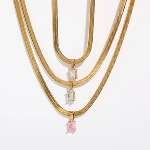 Three gold snake chain necklaces with rectangular zircon pendants in white, blue, and pink