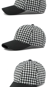 Detail view of houndstooth baseball cap showing textured fabric and six-panel stitching