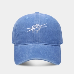Detailed close-up of white drumsticks embroidery on washed navy blue cotton baseball cap