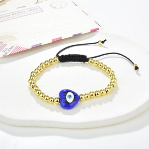 Handmade evil eye beaded bracelet with gold copper beads and blue heart charm