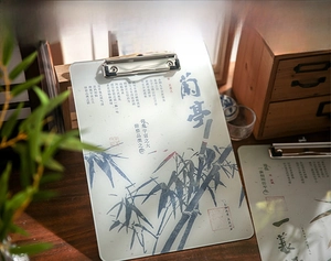 Artistic detail of acrylic clipboard with traditional Chinese ink bamboo and calligraphy