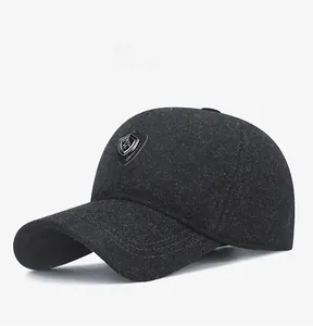 Detail of dark grey winter baseball cap featuring thickened fabric and metal shield logo