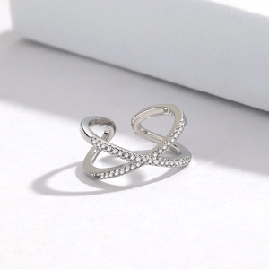 Macro shot of silver minimalist criss-cross ring with pavé-set sparkling cubic zirconia