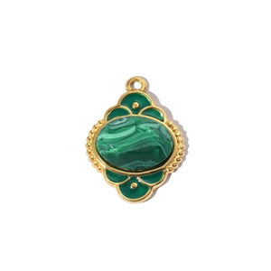 Detail of vintage gold tree of life pendant with green malachite texture inlay