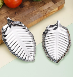Detailed view of large and small golden leaf-shaped stainless steel serving trays