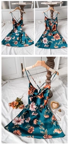 Detail of floral silk satin dress with cross back straps and orange flower print
