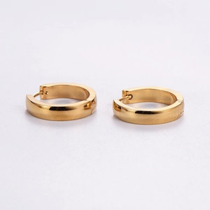Minimalist polished golden stainless steel huggie hoop earrings on white background