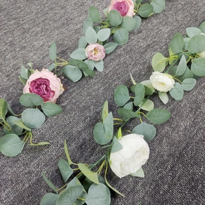 Detail of pink and white silk peony garland with eucalyptus leaves for wedding decor