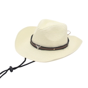Off-white straw cowboy hat with leather band and metal bull head emblem on white backdrop