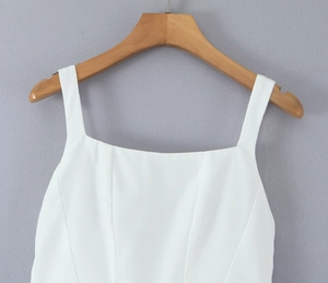 Detail of white square neck princess dress bodice with seam lines on wood hanger