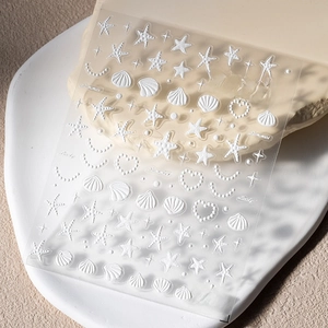 Macro detail of 5D embossed summer ocean nail stickers with shells and pearls