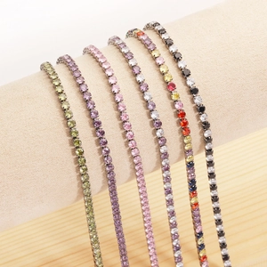 Polished stainless steel tennis bracelets with colorful cubic zirconia on a display stand