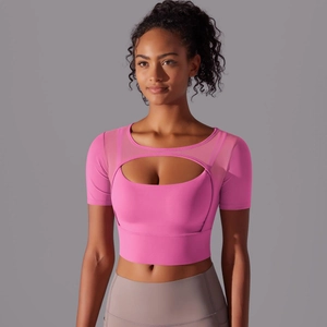 Close-up of pink yoga top with oval mesh cutout and supportive wide hem detail