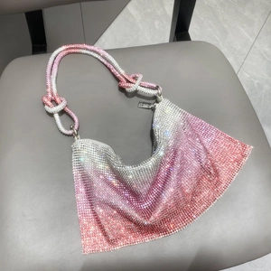 Close-up of pink gradient rhinestone handbag featuring a unique silver knotted handle design