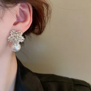 Elegant silver snowflake earrings with sparkling cubic zirconia and white hanging pearls