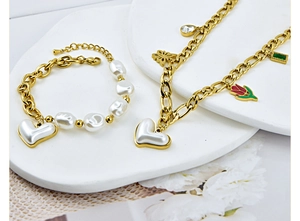 Detailed set of gold chain necklace and bracelet with heart pendants and pearls