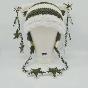Detail of hand-knitted cat ear hat with stars and cream faux fur trim in striped dark green