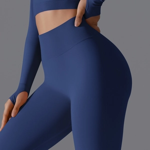 Detail showing ribbed high-waist band and thumbholes of a blue seamless yoga set