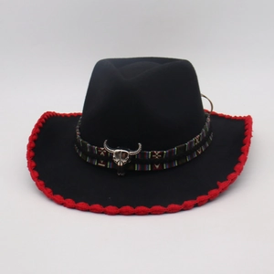 Detail of black wool cowboy hat with red crochet trim and silver bull head emblem