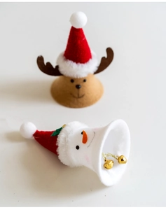 Detail of fabric reindeer and snowman Christmas ornaments with metal bells