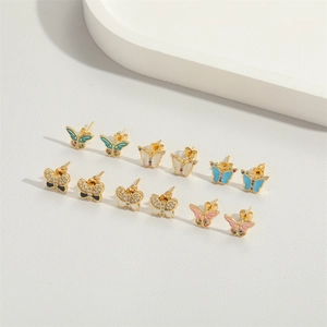 Detailed set of six golden butterfly stud earrings with colorful enamel and rhinestones