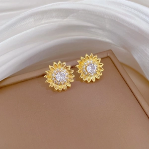 Detailed close-up of golden sunflower stud earrings with shimmering zircon crystals