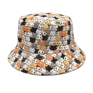 Close-up detail of cute cartoon cat pattern on reversible cotton bucket hat