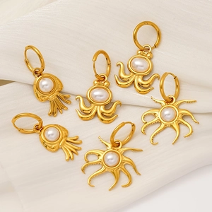 18K gold plated octopus and squid hoop earrings with pearls on white fabric