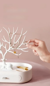 White antler jewelry rack with drawer base for organizing necklaces and earrings