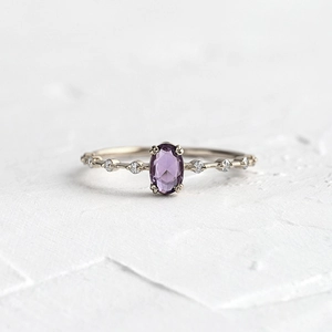 Elegant 18k gold plated ring with oval purple zircon and sparkling side stones