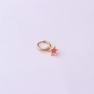 Detail of a gold stainless steel hoop earring featuring a red enamel star charm pendant