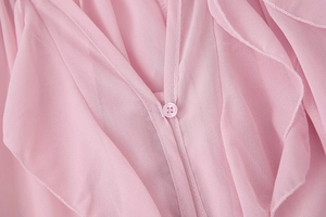 Close-up of elegant pink chiffon V-neck blouse showing fabric texture and matching buttons