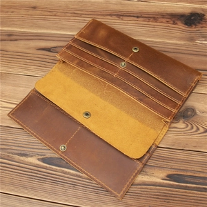 Detail of vintage crazy horse leather wallet with multiple card slots and metal snap button