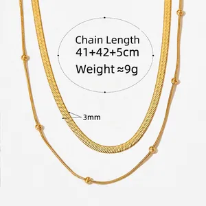 Gold double-layered stainless steel necklace featuring snake chain and bead accents