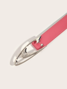 Detail of pink faux leather belt featuring silver rhinestone-encrusted orbital buckle